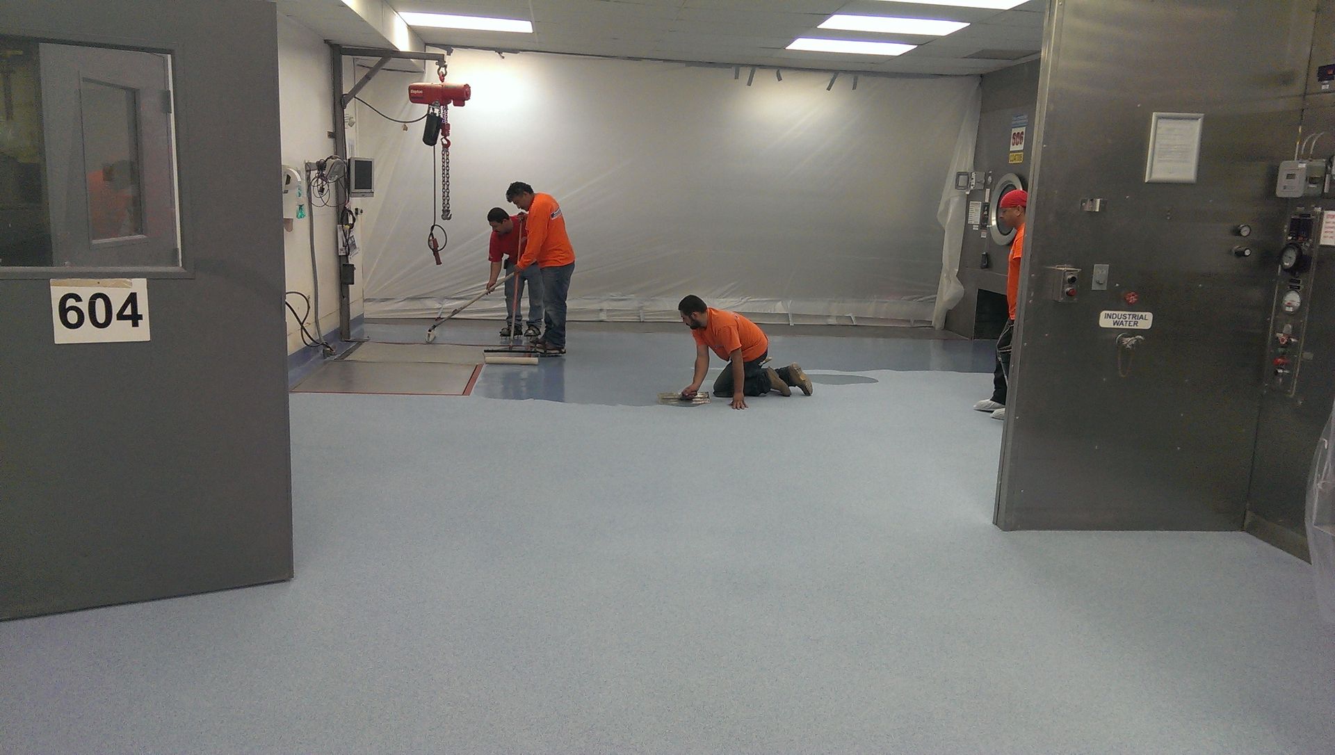 Pacific Coast Contracting crew installing a seamless resin floor inside an industrial facility