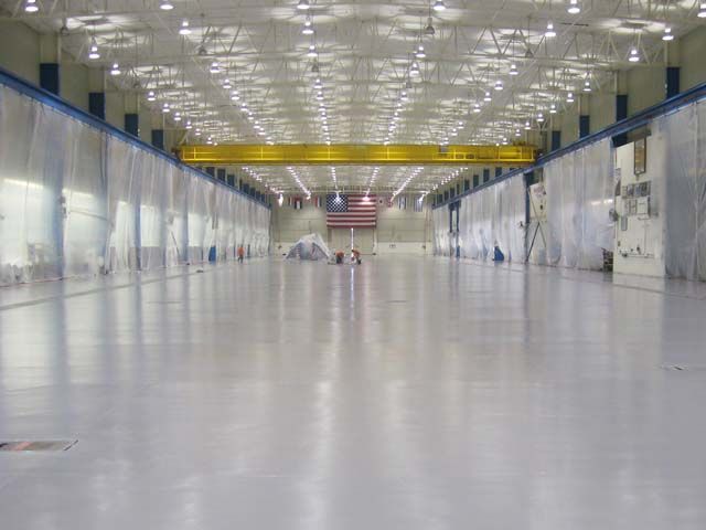 Large aerospace hangar with a light gray coated floor