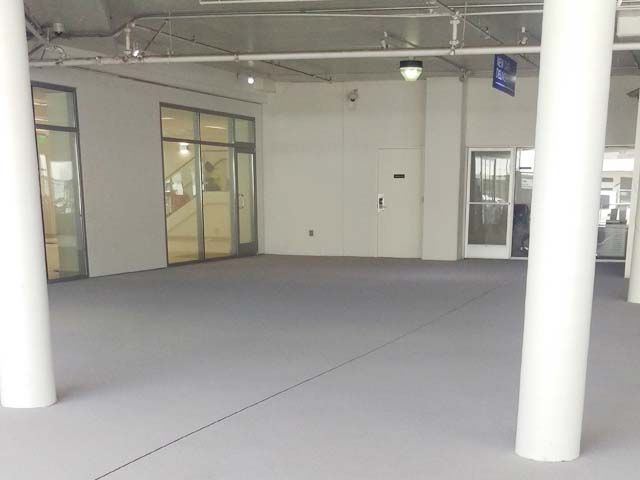 Gray epoxy floor in an automotive showroom space