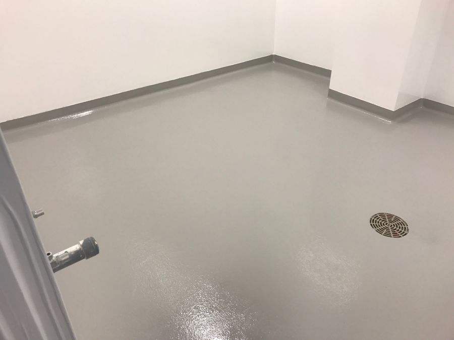 Gray antimicrobial floor with integral cove base in a hospital room